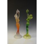 Two Art Deco-style glass figures of naked maidens holding aloft bunches of grapes, one yellow and