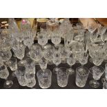 Large quantity of table glass, decanters etc, and a glass block with decoration of a crane, the base
