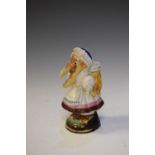 Ceramic match holder figure of a Pelican wearing a white and pink frilled dress, 15cm high