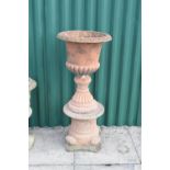 Terracotta garden urn of campana form on socle and pedestal, 46cm diameter x 110cm high