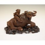 Early 20th Century Chinese carved hardwood model of a water buffalo and rider, each with bone teeth,