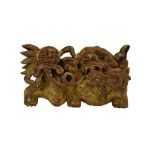 19th Century Chinese carved giltwood wall pendant, modelled as a shishi playing with a pierced