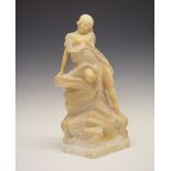 Early 20th Century carved alabaster figure of a semi-naked maiden, modelled seated upon a rocky