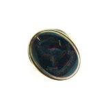 Unmarked yellow metal and bloodstone signet ring, the oval matrix intaglio-carved with the head of a