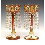 Pair of late 19th Century Bohemian overlay cranberry glass table lustres, each with alternate