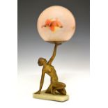Art Deco gilt spelter figural table lamp, modelled as a kneeling semi-naked female holding aloft the