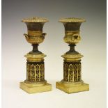 Pair of 19th century gilt brass and bronze pedestal urns, each of two-handled campana form with