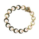 Yellow metal flexible bracelet, of repeating crescent design set with sixteen opal circular