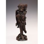 Early 20th century Oriental carved hardwood figural candlestick, modelled as a robed figure