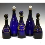 Five 'Bristol' blue glass decanter bottles, the two largest with stoppers for Gin and Brandy, two