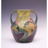 Large Moorcroft baluster two-handled vase with Koi carp pattern decoration on green ground, designed