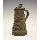 Late 19th Century bronzed silver-plated wine jug, the cover modelled as a reclining figure, over