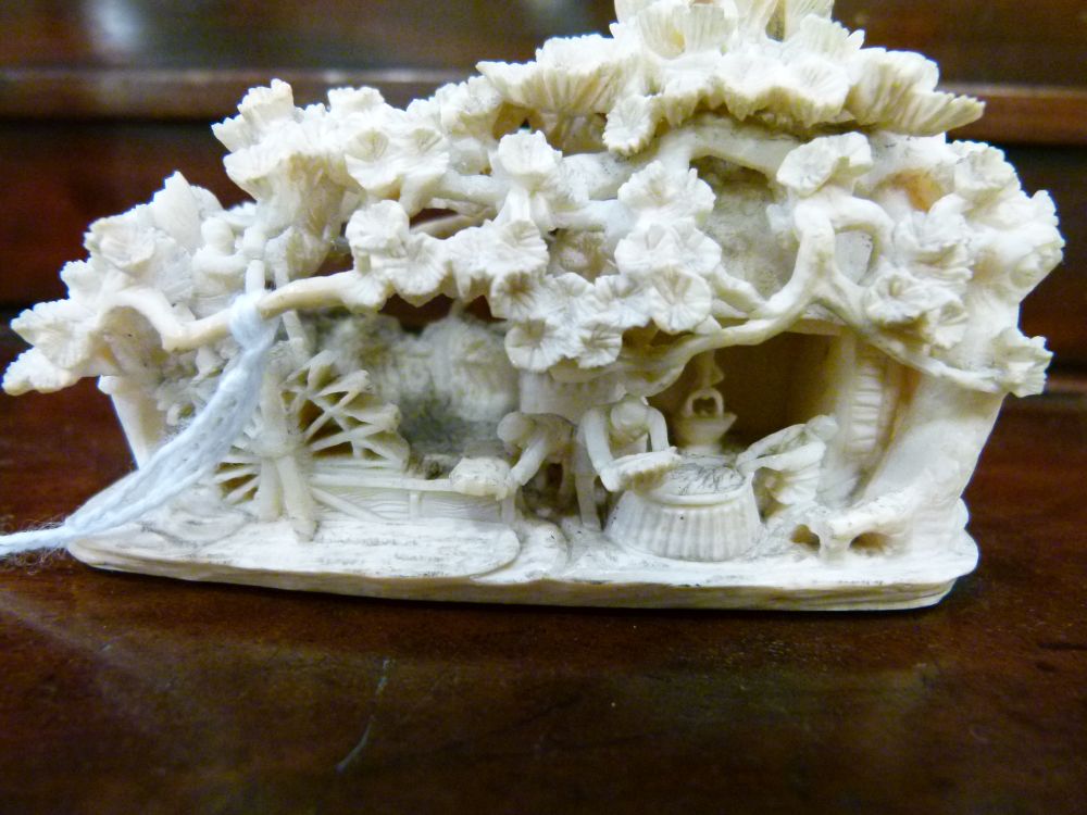 Japanese Meiji period carved ivory okimono, depicting figures outside a thatched mill cottage - Image 2 of 8