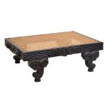 19th Century Ceylonese Colonial carved ebonised footstool, the cane top on reeded frame with foliate
