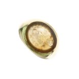 Unmarked yellow metal signet ring, with oval hardstone intaglio seal carved with a seahorse recto