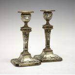 Pair of Edward VII silver candlesticks, in the Neo Classical-style, having a raised square