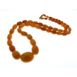 Graduated string of amber beads, largest approx 22mm wide, total length 60cm approx, 34.8g gross