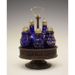 George III 'Bristol' blue glass five-bottle cruet, each of faceted form with gilt labels for Oil,