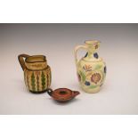 Victorian Greek style painted terracotta lamp and two sgraffito decorated pottery jugs, the