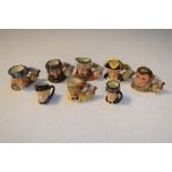 Eight Royal Doulton miniature character jugs with stand