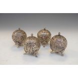 Four Eastern white metal pepperettes of spherical form on three paw feet, 6toz approx