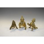 Three Indian bronze figures of crouching children, the largest 7.5cm high (3)