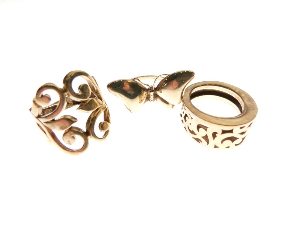 Two 9ct gold dress rings, one formed as a butterfly, size P, the other with foliate scroll work,