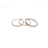 Set of three 9ct gold rings comprising: two yellow and one white gold respectively, each with