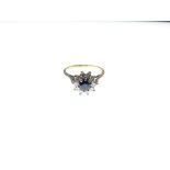 18ct gold, diamond and sapphire cluster ring, the central stone within ten diamonds, size L½, 3.7g