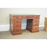 Early 20th Century walnut twin pedestal desk fitted nine drawers with an inset writing surface,