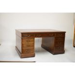 Early 20th Century mahogany partners desk having inset red leather writing surface, fitted nine