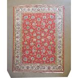 Persian Tabriz wool rug or carpet decorated with flowers and foliage on a crimson ground within