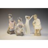 Pair of Lladro geisha figures, one other Lladro figure of a boy on a tree stump and a Nao figure