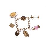 Yellow metal charm bracelet, 9ct gold padlock and assorted charms, 52.3g gross approx