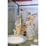 Nao figural table lamp, four Lladro figures and a Lladro 1975 plate