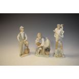 Two Lladro figures and a Nao figure of a boy seated on a fire hydrant, the tallest 28cm high