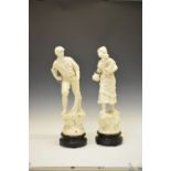 Pair of early 20th Century spelter figures of fisherfolk, later cream-painted, on turned wooden base