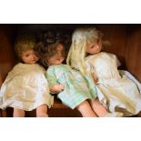 Three vintage 20th Century composite headed children's dolls in various dresses