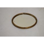 Oval reeded gilt framed mirror, 42cm high