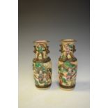 Pair of Japanese pottery vases decorated with warriors, 23.5cm high