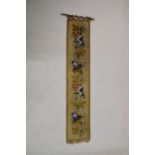 Needlework tapestry hanging, 24cm wide x 123cm high excluding brass hanging rail