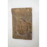 Primitive relief-carved wooden panel decorated with a figural bust, 42cm x 28cm