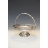 George V silver cake basket with swing handle and pieced gallery, both with rope twist edge,