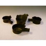 Four Oriental bronze vessels having hollow handles, 9cm high
