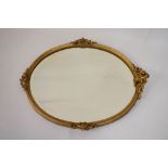 Oval gilt framed mirror having carved cresting, 72cm high