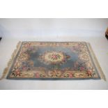 Chinese wool rug, the powder blue field with 'carved' floral decoration, 121cm x 185cm