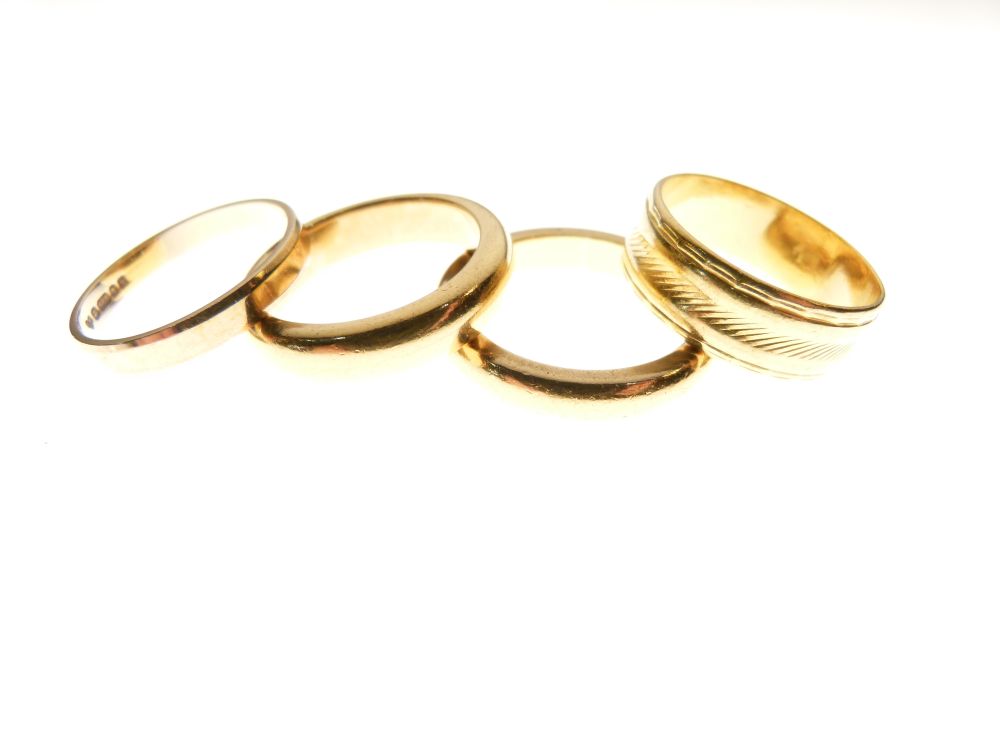 Three 22ct gold wedding bands, total 25g approx, together with a 9ct gold wedding band, 1.6g