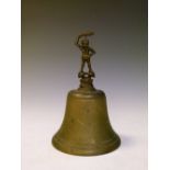 Bronze and alloy bell, the handle formed as a pixie with raised club, 20cm high