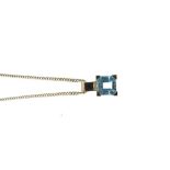 Yellow metal pendant with square-cut aquamarine-coloured stone, loop stamped 333, together with a