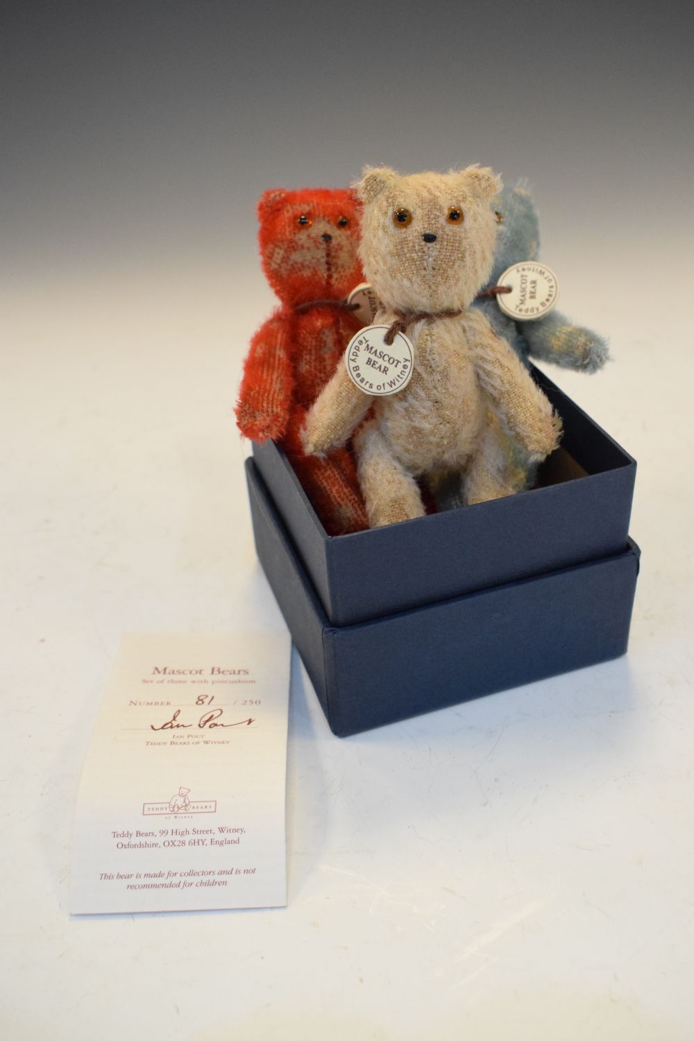 Three 'Teddy Bears of Witney' mascot bears, approximately 12cm high, together with a miniature Union